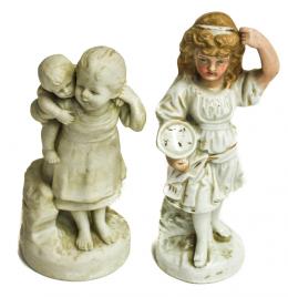 519 - DOS FIGURAS EN BISCUIT Y PORCELANA
