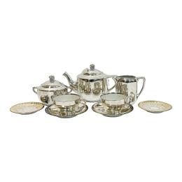 729 - JUEGO DE TÉ EN PORCELANA PLATEADA